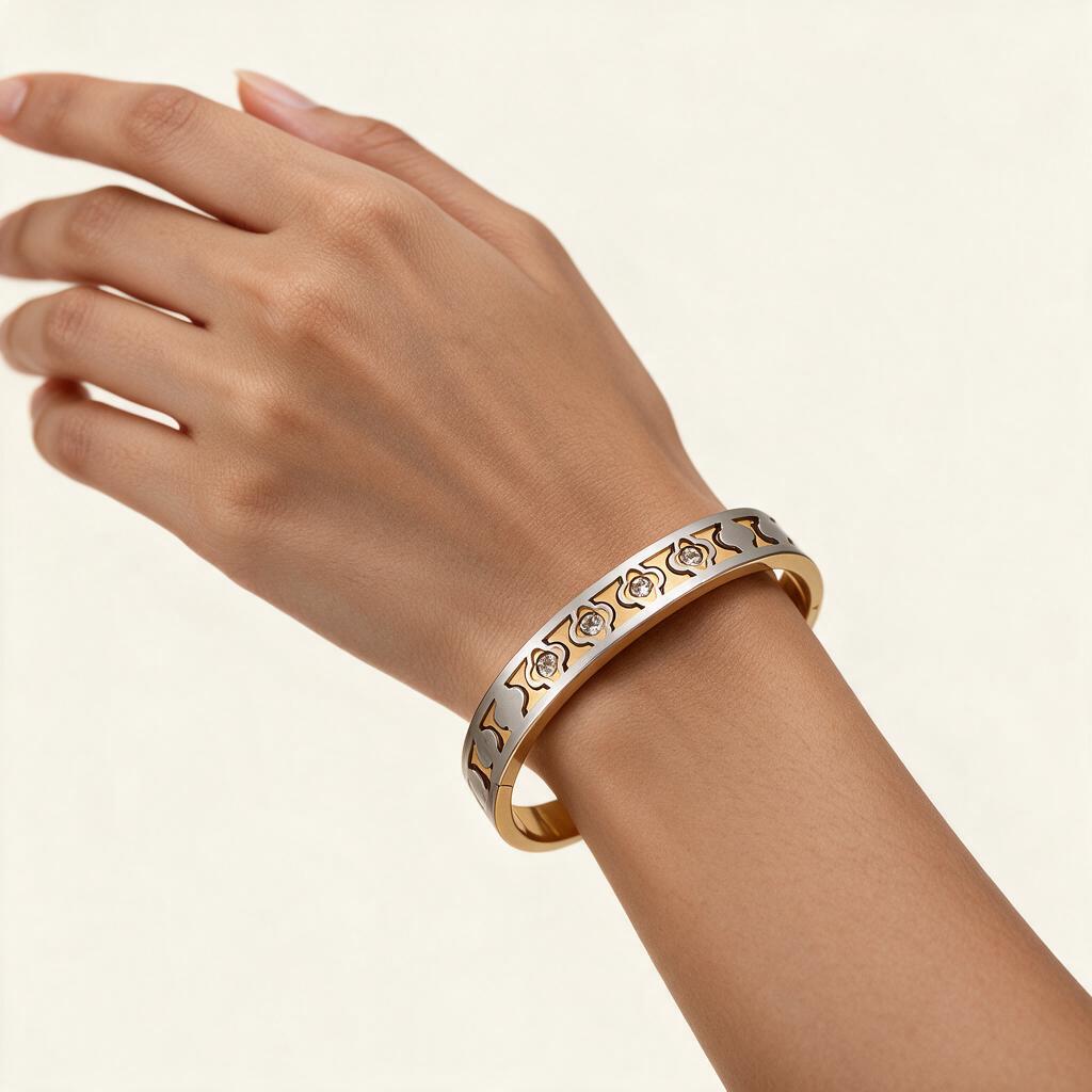 Woman wearing the Sinclair two tone clover lattice hinged bangle on her wrist