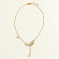 Gold-tone necklace with pear crystal leaf pendant and pearl on ivory background