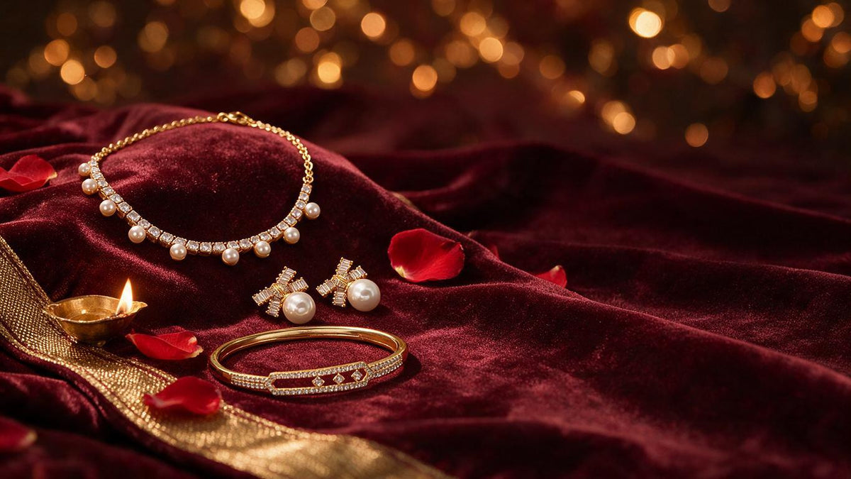 Pearl and crystal necklace, bow studs and a pave bangle on deep maroon velvet with gold zari, a diya and red rose petals