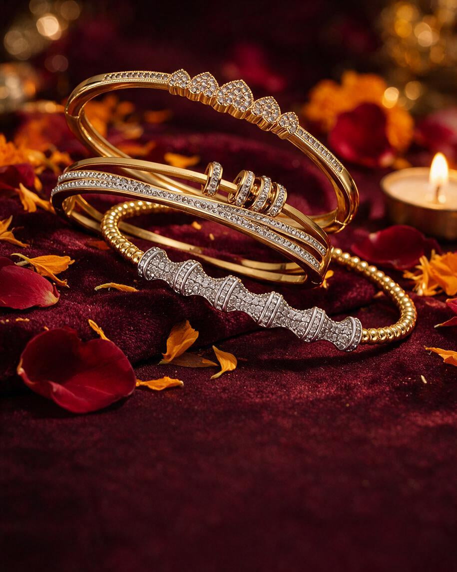 Gold and silver tone pave bangles stacked on dark maroon velvet with marigold petals and a lit brass tealight