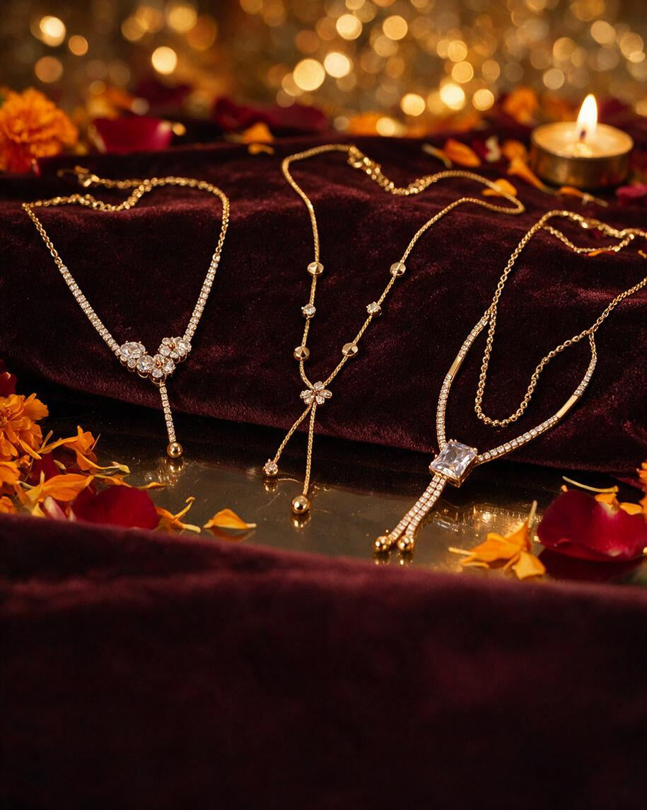 Layered crystal and pearl chains on dark maroon velvet with marigold petals and a tealight